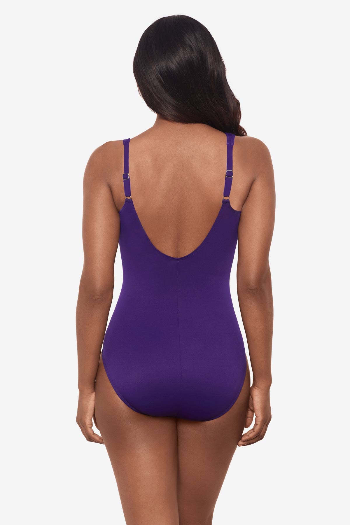 Woman facing away wearing a mulberry purple one-piece swimsuit