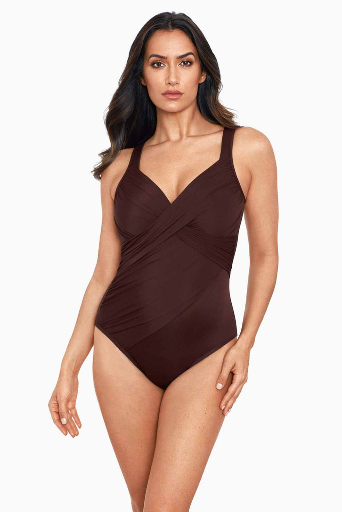 Woman wearing a miracle suit one piece swim suit.