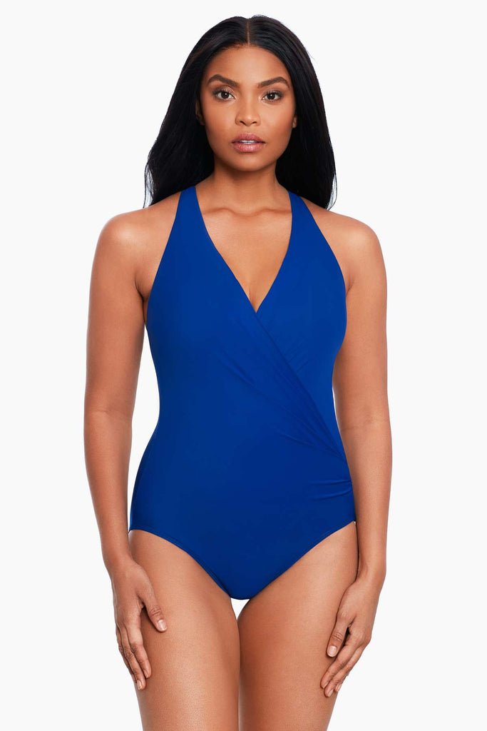 An african american woman wearing a one piece swim suit.