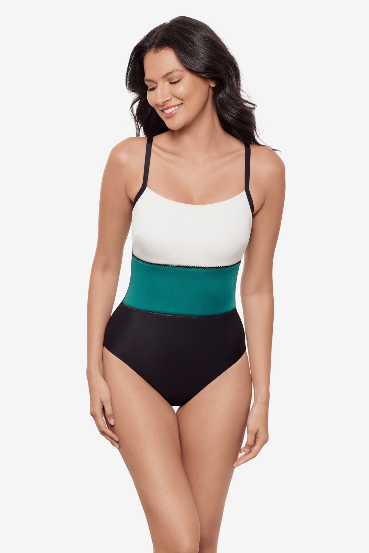 Woman wearing a white, blue and black color block one-piece swimsuit