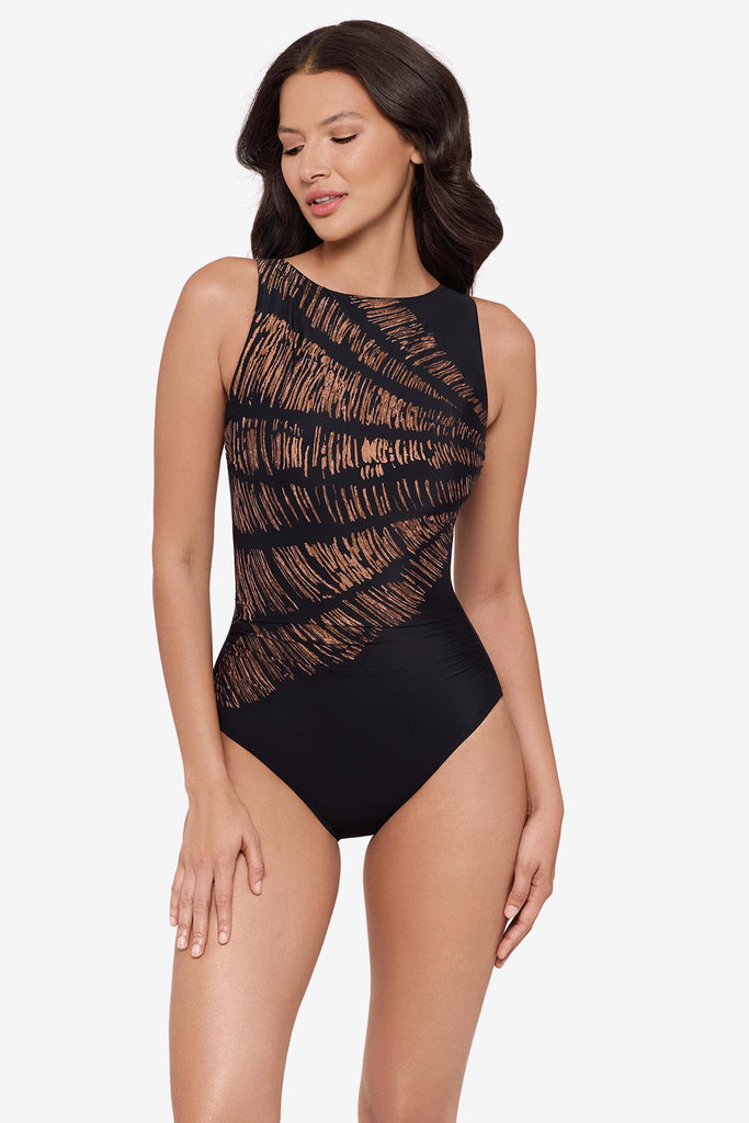 Woman wearing a black and brown printed one-piece swimsuit with a high neckline