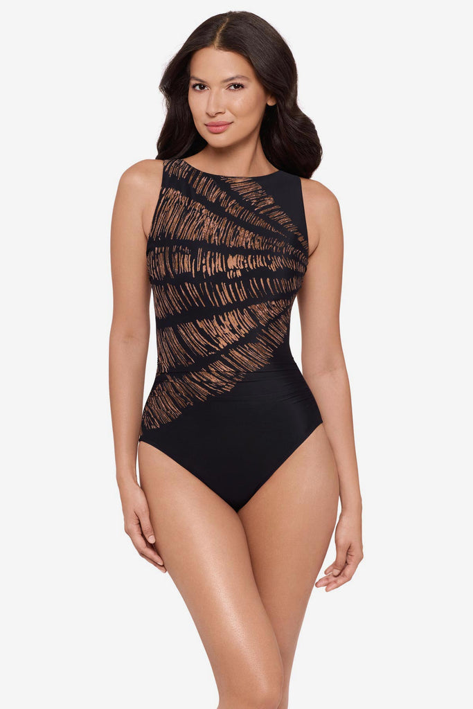 Woman wearing a black and brown printed one-piece swimsuit with a high neckline