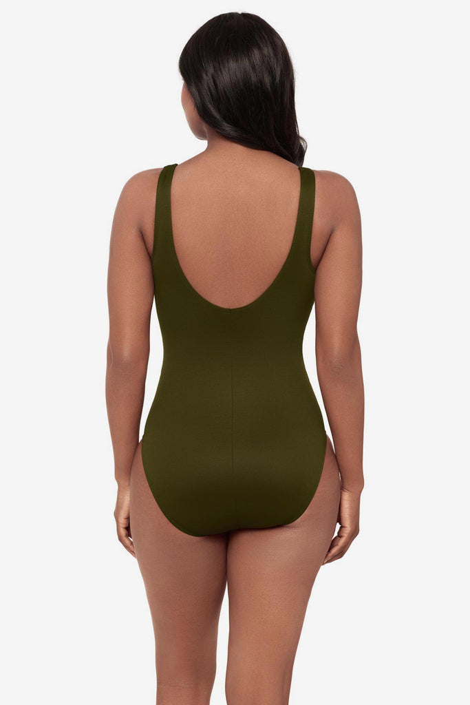 Woman turned away wearing a green one-piece swimsuit 