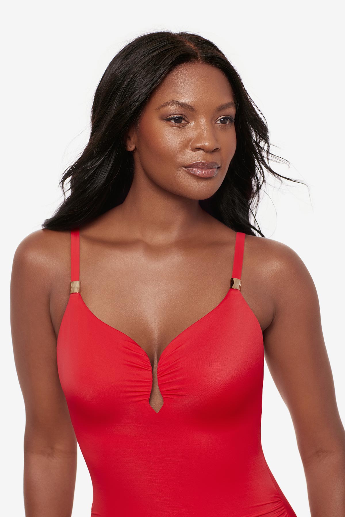 Woman wearing an orange one-piece swimsuit with a sweetheart neckline