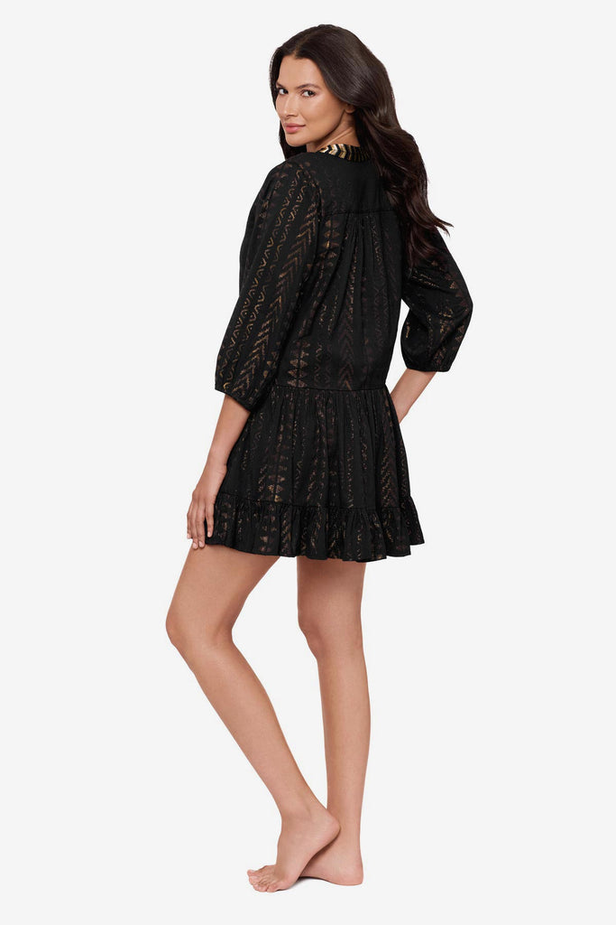 Woman turned left wearing a black pull-over kimono swim dress