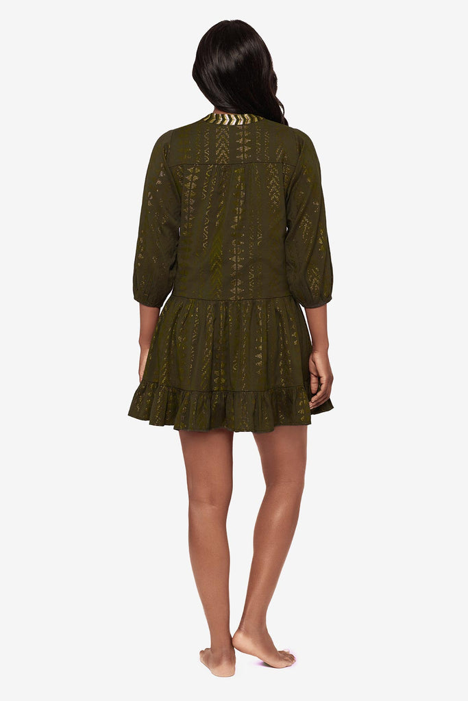 Woman turned away wearing a green pull-over kimono swim dress 