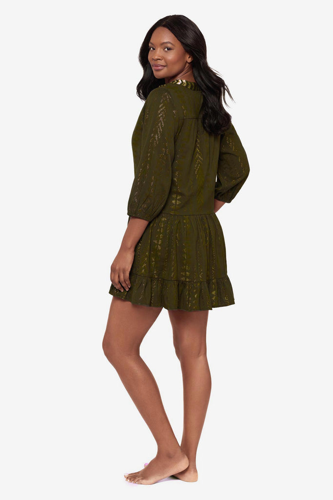 Woman turned left wearing a green pull-over kimono swim dress 