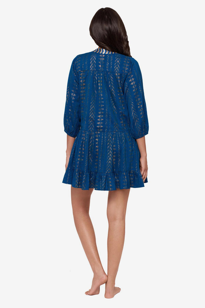 Woman turned away wearing a blue pull-over kimono swim dress 