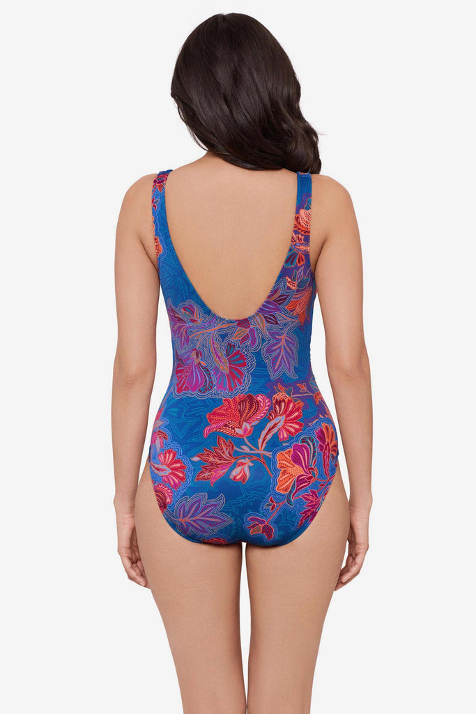 Woman turned away wearing a multicolor red flower print one-piece swimsuit