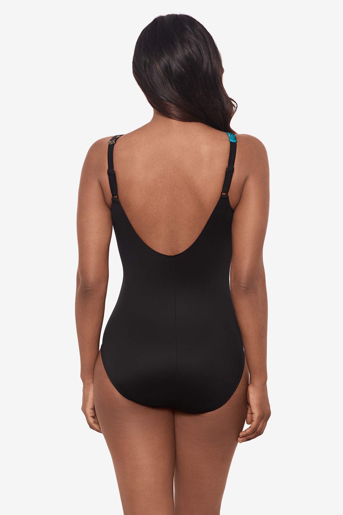Woman facing away wearing a multicolor one-piece swimsuit
