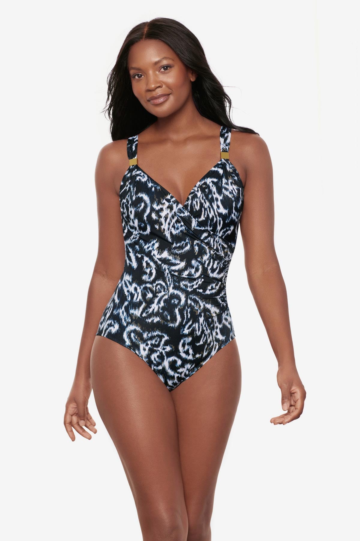 Woman wearing a black and white abstract printed one-piece swimsuit