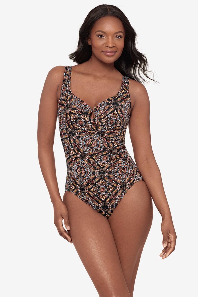 Woman wearing a multicolor abstract one-piece swimsuit with a sweetheart neckline
