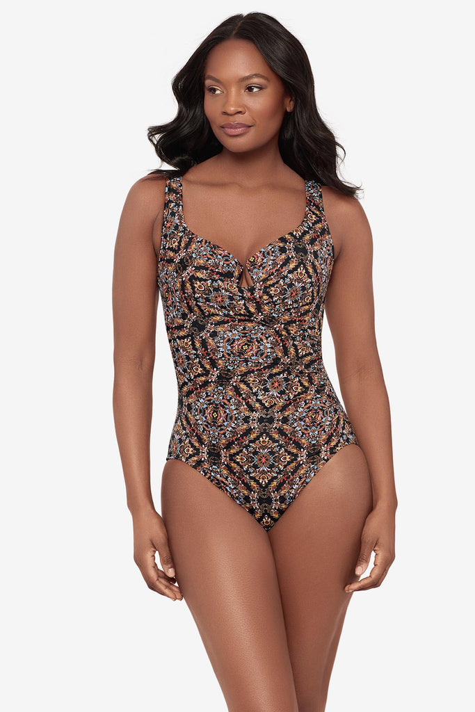 Woman wearing a multicolor abstract one-piece swimsuit with a sweetheart neckline