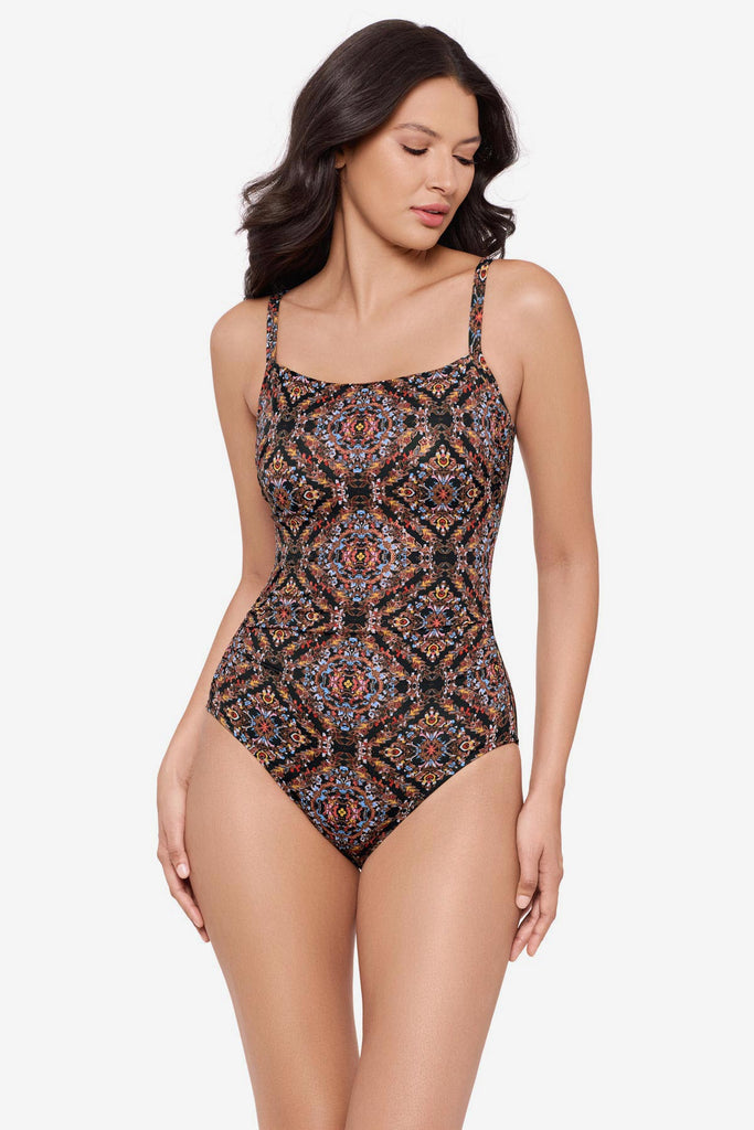 Woman wearing a multicolor abstract one-piece swimsuit