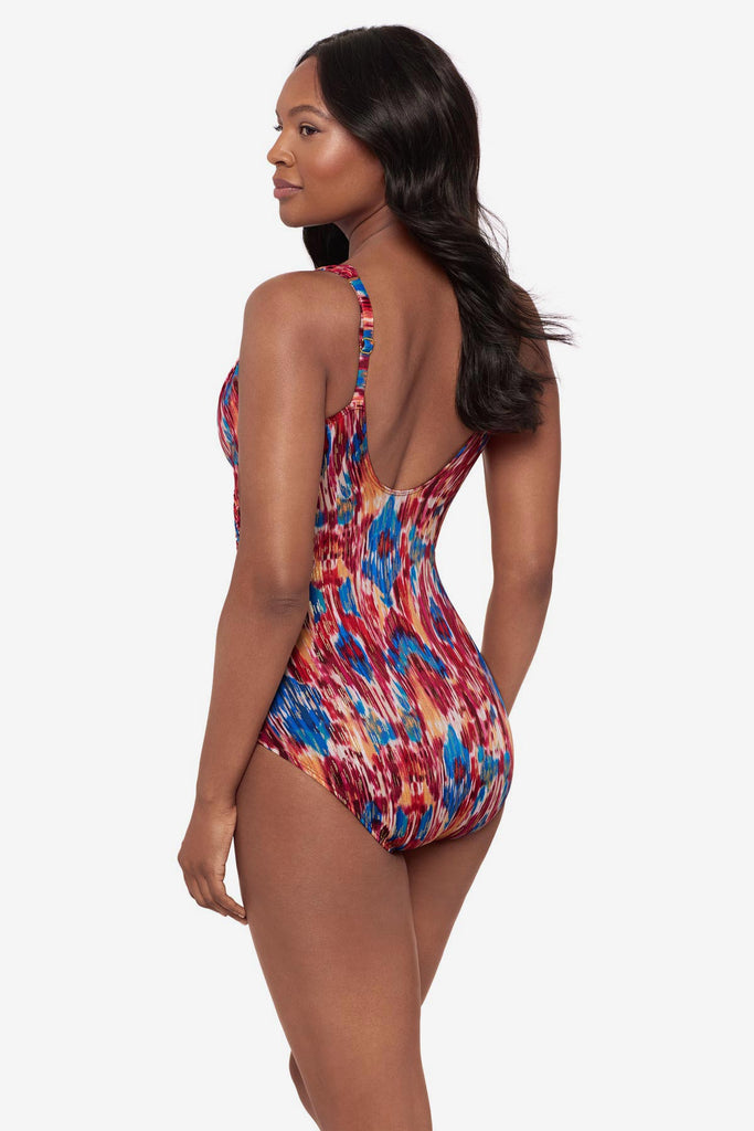 Woman turned left wearing a multicolored one-piece swimsuit
