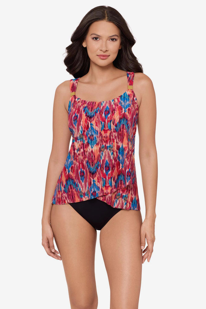 Woman wearing a multicolored tankini top with embellishments on the straps