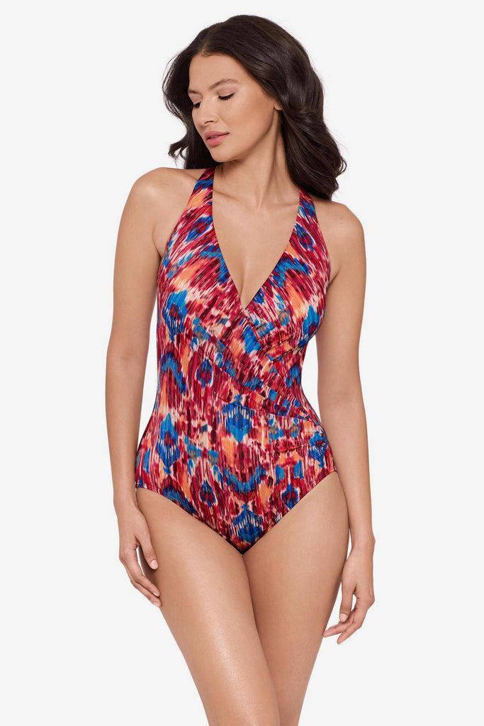 Woman wearing a multicolored one-piece swimsuit with a V neckline