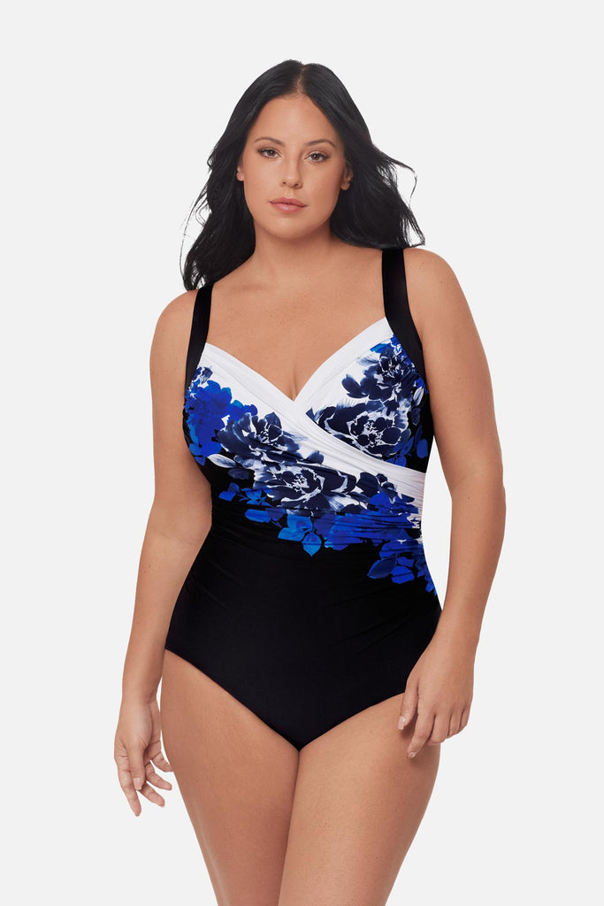 Woman wearing a blue floral pattern one-piece swimsuit