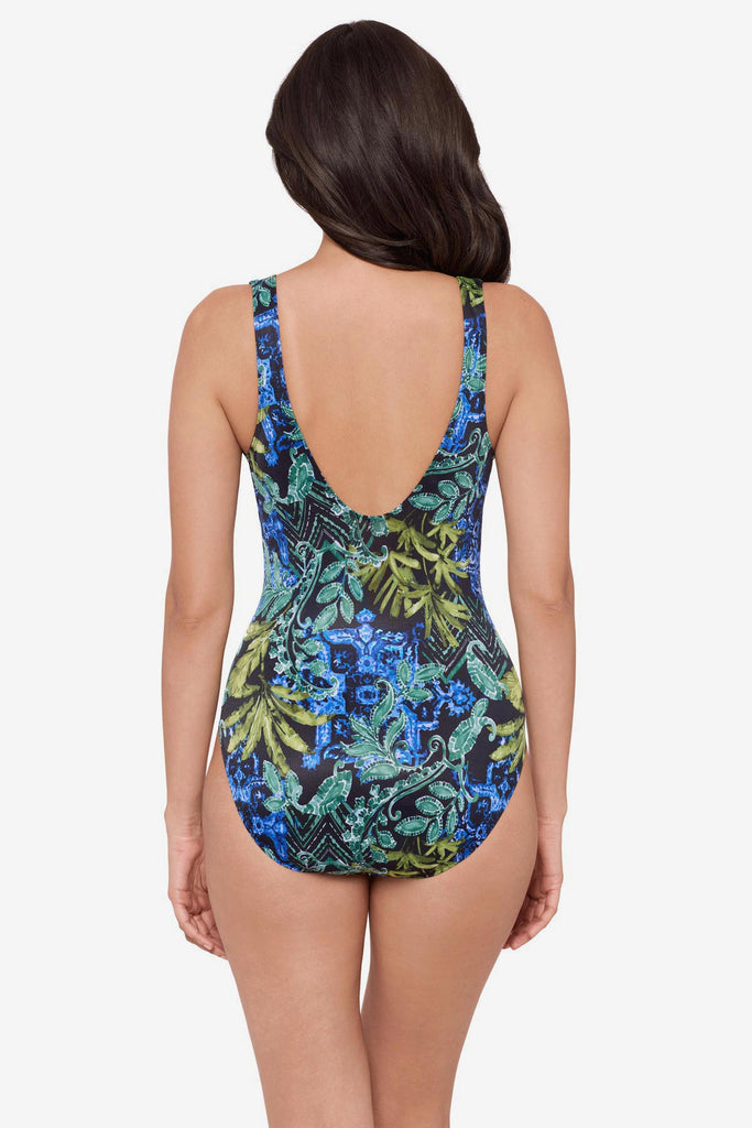 Woman turned away wearing a multicolor one-piece swimsuit with an abstract print