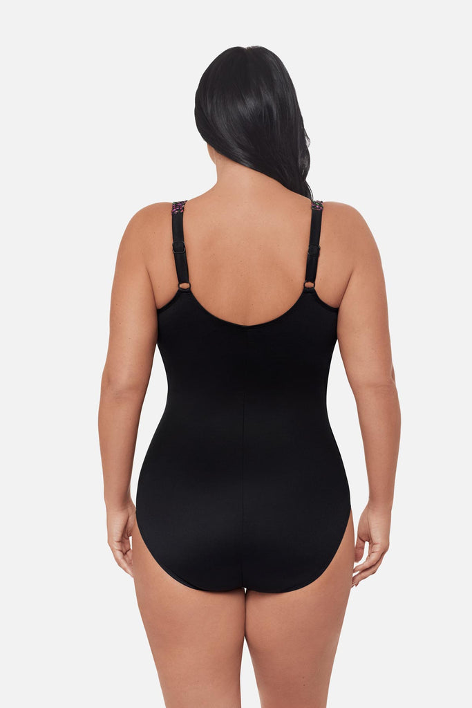Woman turned away wearing a one-piece swimsuit with adjustable straps