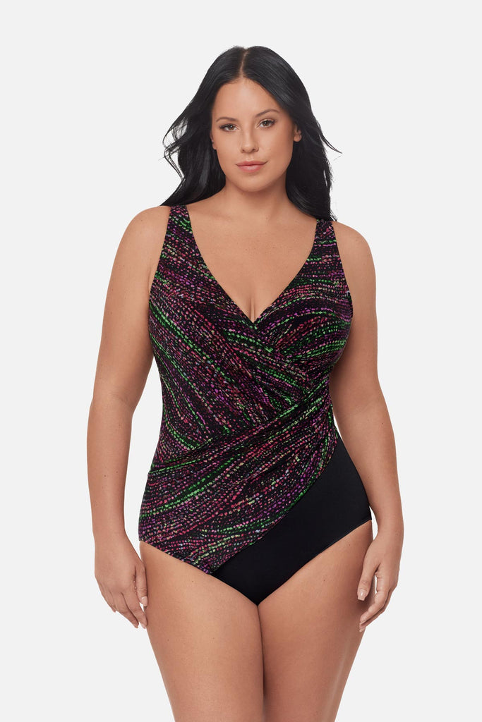 Woman wearing a multicolored dot pattern one-piece swimsuit