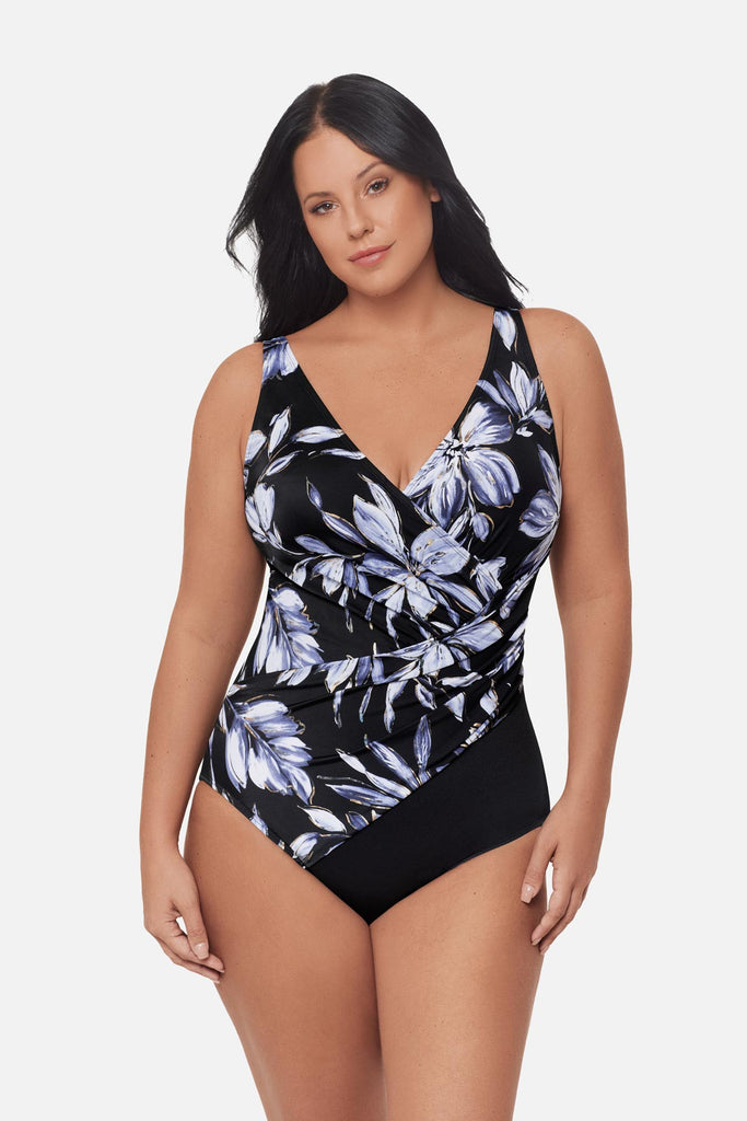 Woman wearing a white floral printed one-piece swimsuit