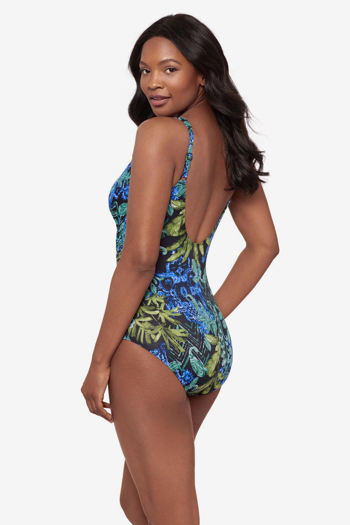 Woman turned left wearing a blue and green abstract printed one-piece swimsuit