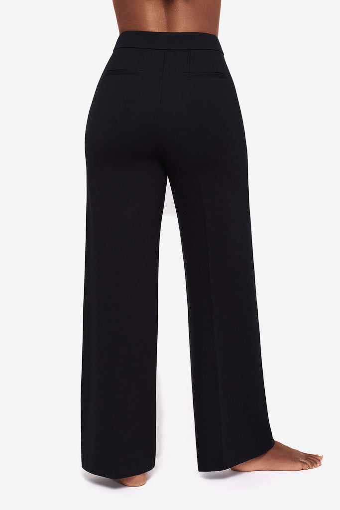 Close up of back of Woman's legs in black wide legs pants