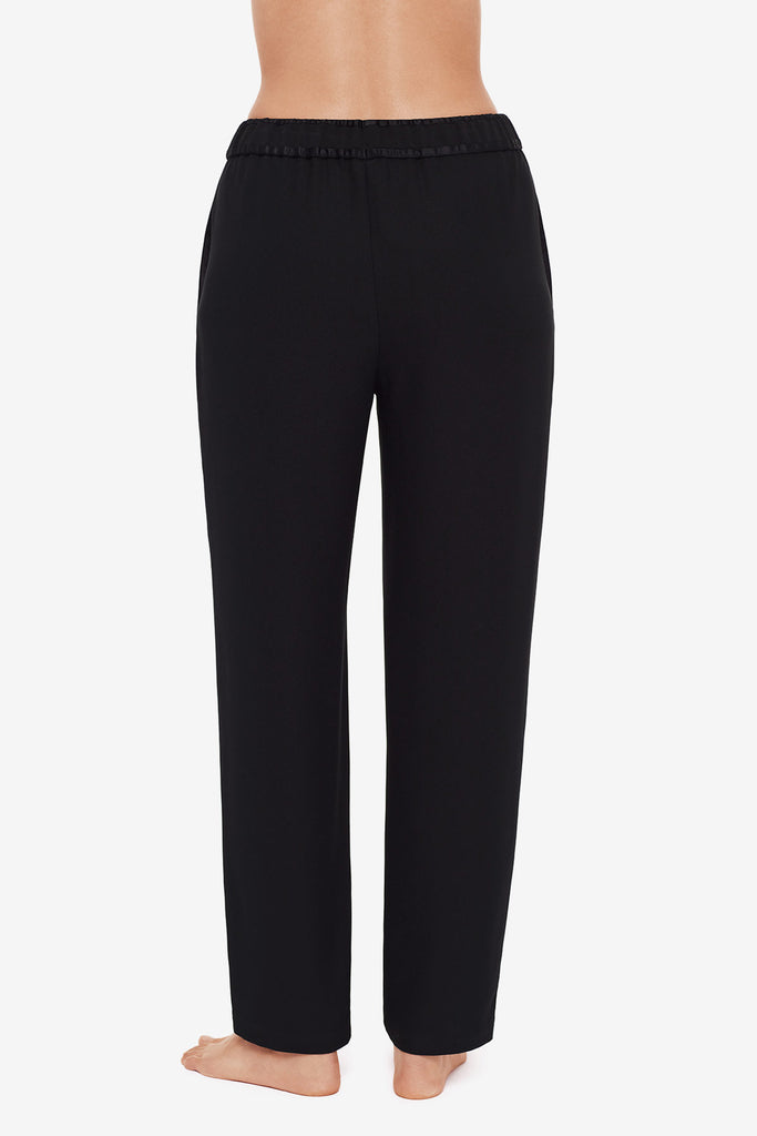 Close up of back of woman's legs in black jogger pants