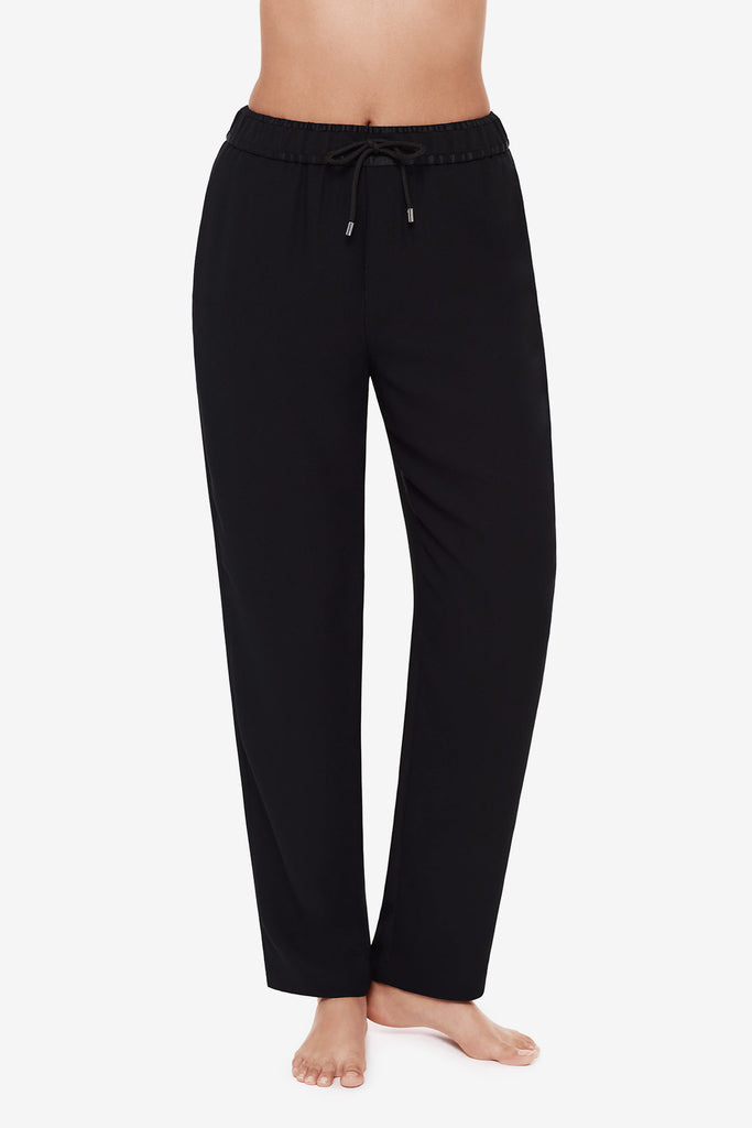 Close up of woman's legs in black jogger pants