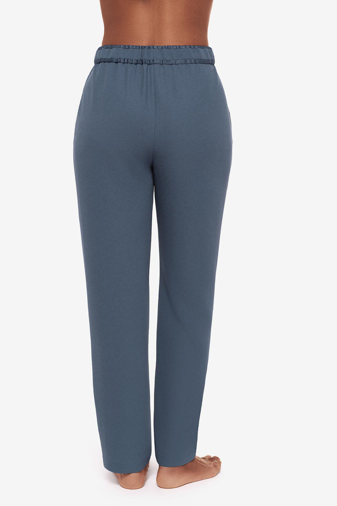 Close up of back of woman in blue jogger pants