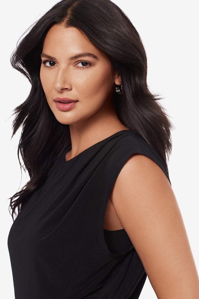 Close up of woman wearing a drapey black blouse 