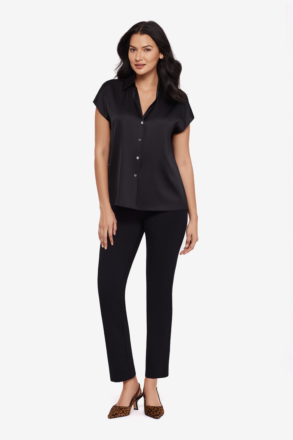 Woman wearing a black button-down blouse with short sleeves with matching black pants