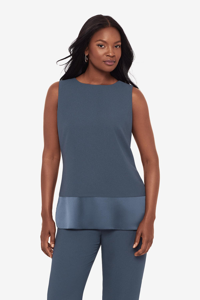 Close up of woman wearing a blue layered tunic blouse