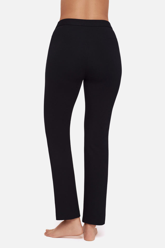 Close up of back of woman wearing black slim fit pants