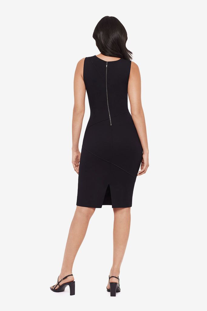 Woman turned away wearing a black knee length dress with a scoop neck