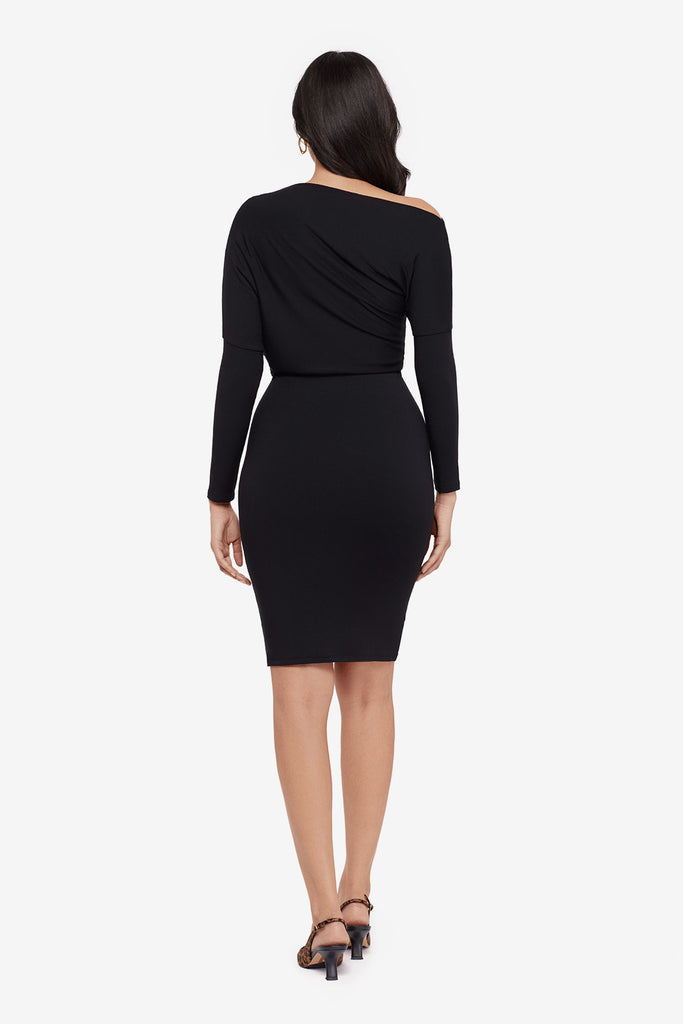 Woman faced away wearing a black long sleeve dress at knee length