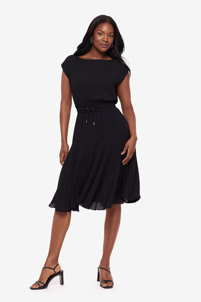 Woman wearing a black short sleeve dress with a drawstring detail