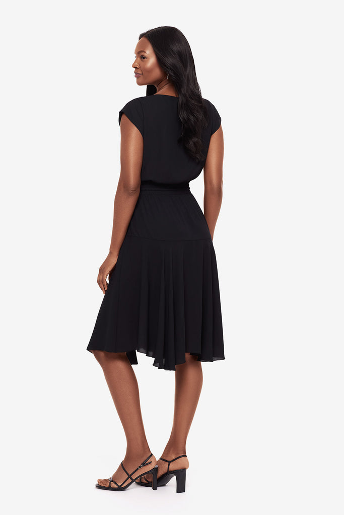 Woman faced left wearing a black short sleeve dress with a drawstring detail