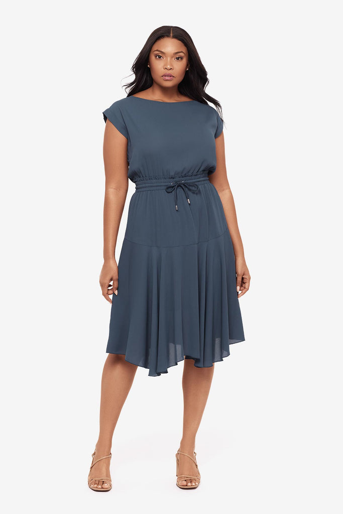 Woman wearing a blue short sleeve dress with a drawstring feature
