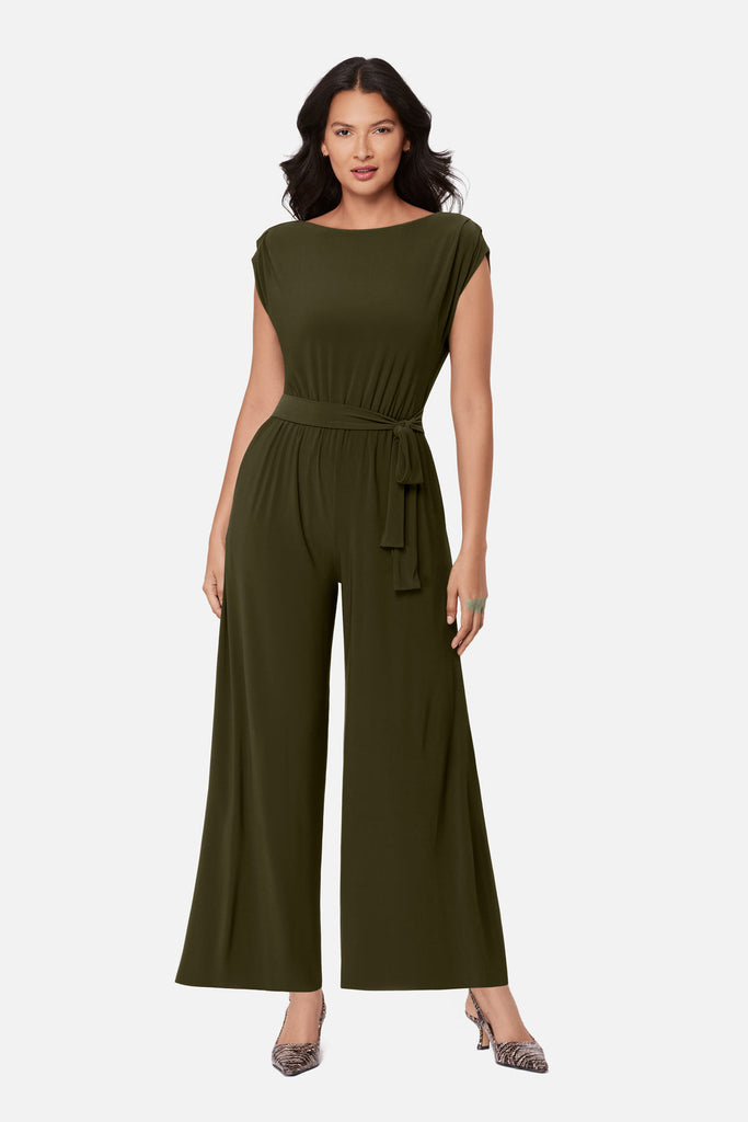 Woman wearing a green romper with a sash around the waist