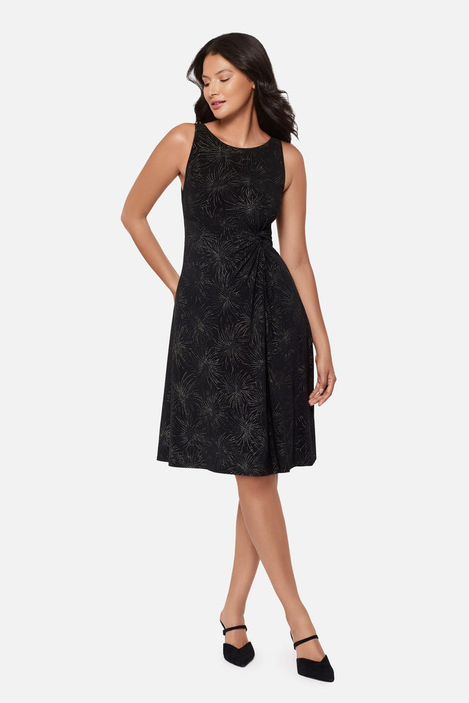 Woman wearing a black sparkle printed knee length dress