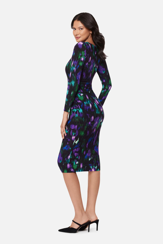 Woman turned left wearing a multicolored print long sleeve dress