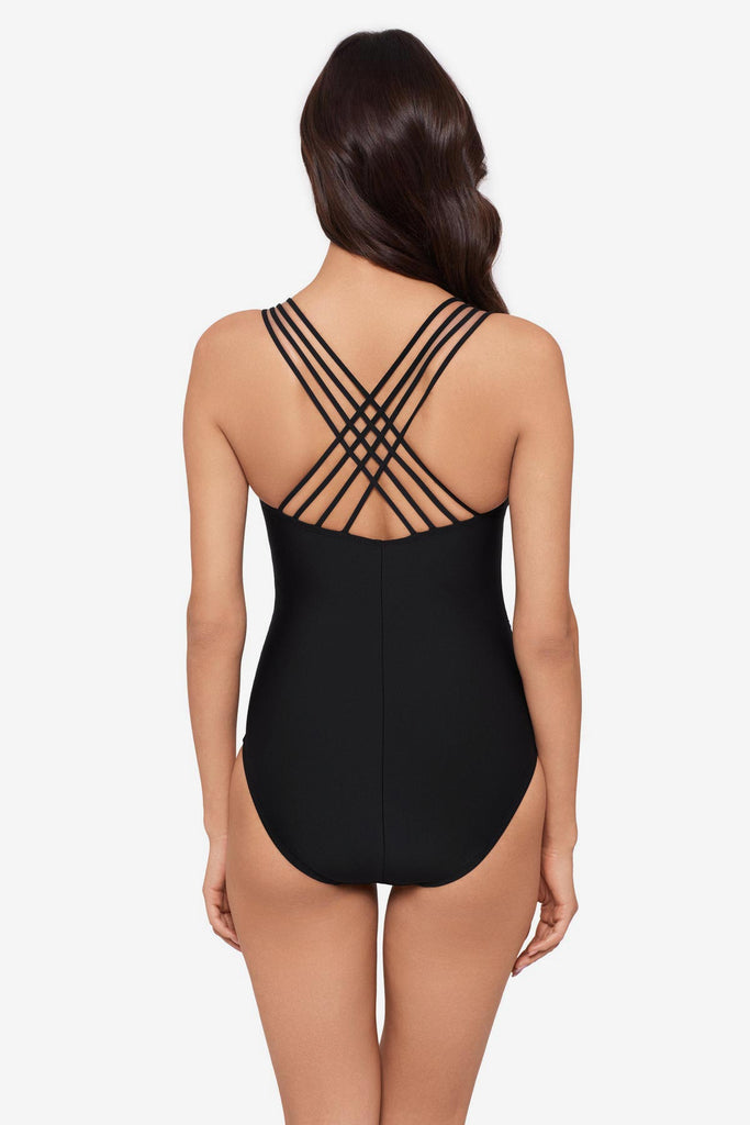 Woman turned away wearing a black one-piece swimsuit with an X back detail