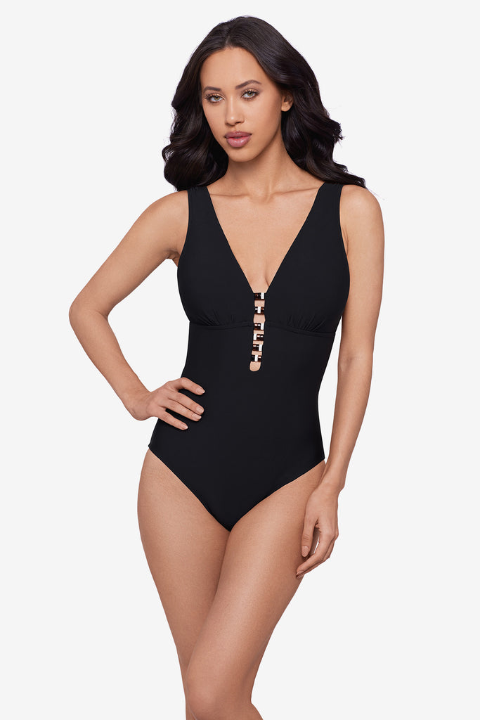 Woman wearing a black one-piece swimsuit with beading down the front