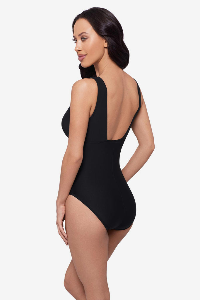 Woman faced left wearing a black one-piece swimsuit with beading down the front