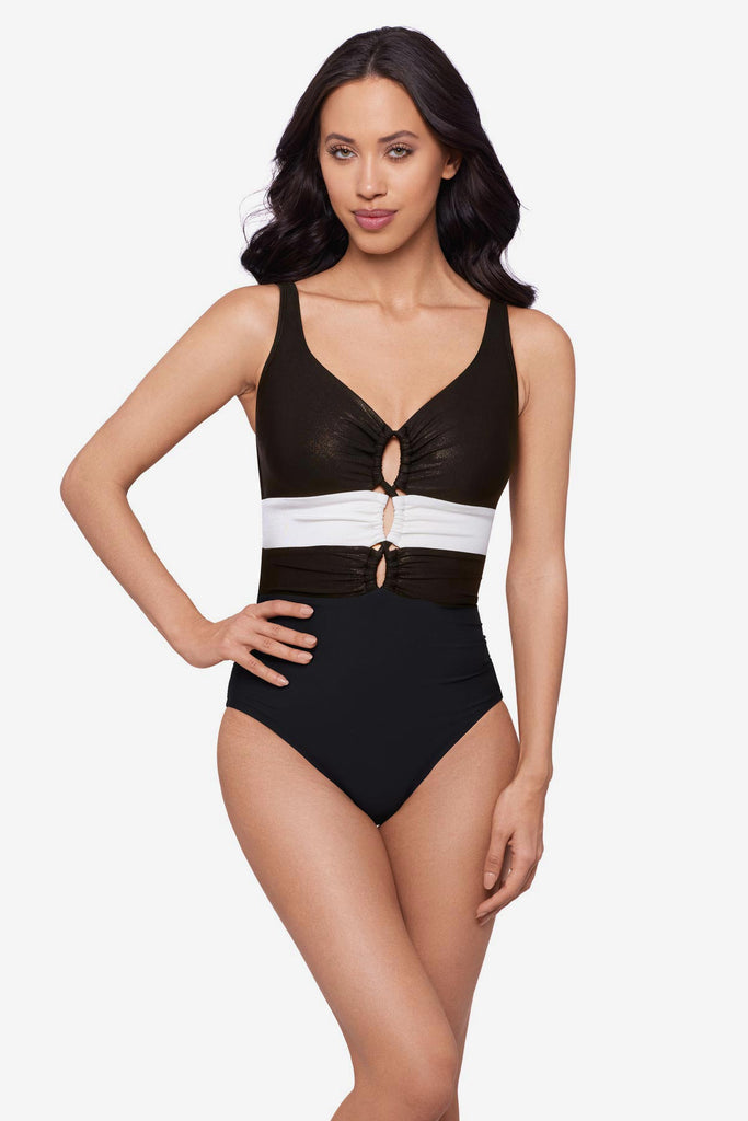Woman wearing a black one-piece swimsuit with a white stripe in the middle