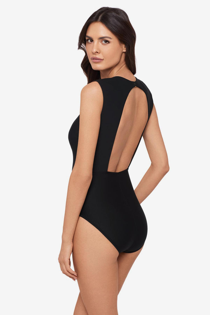 Woman turned left wearing a black one-piece swimsuit with short sleeves