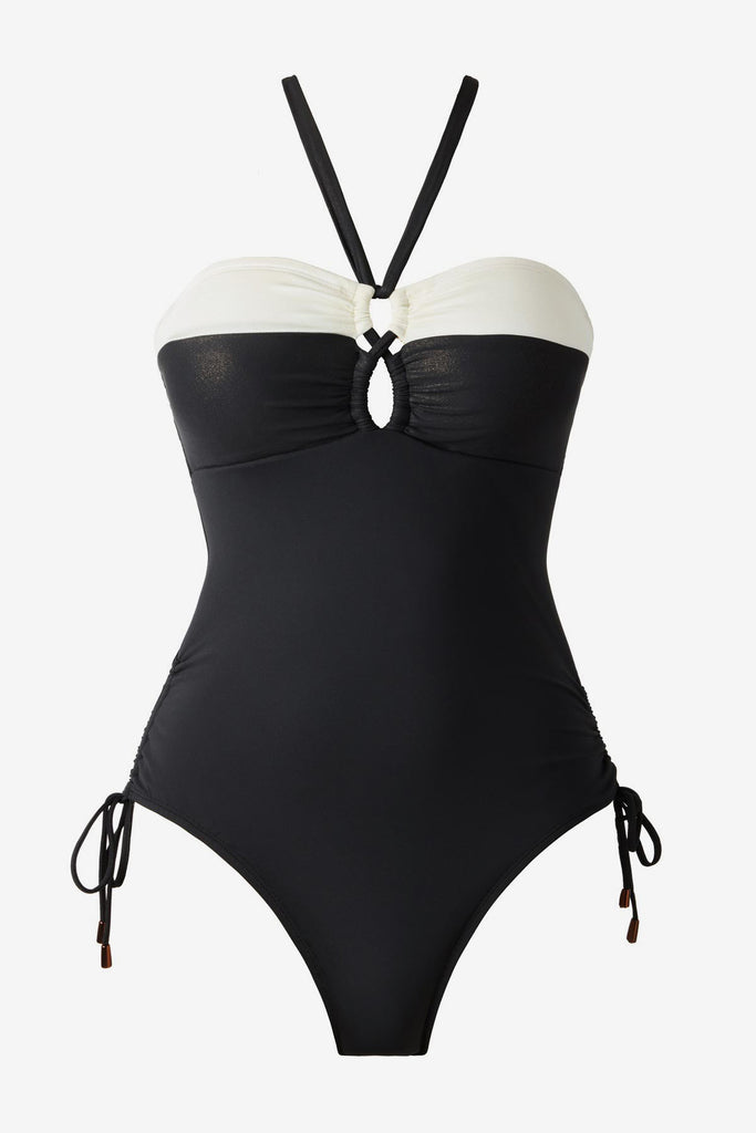 Black halter top swimsuit with a white stripe along the chest