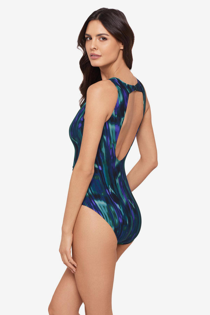 Woman faced left wearing a green tie-dyed one -piece swimsuit
